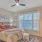 Spacious and well lit bedroom with wood floors and large windows