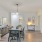 Spacious and well lit dining area with wood floors and access to the living room 