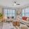Spacious and well lit living room with wood floors and an open floor plan with access to the kitchen.